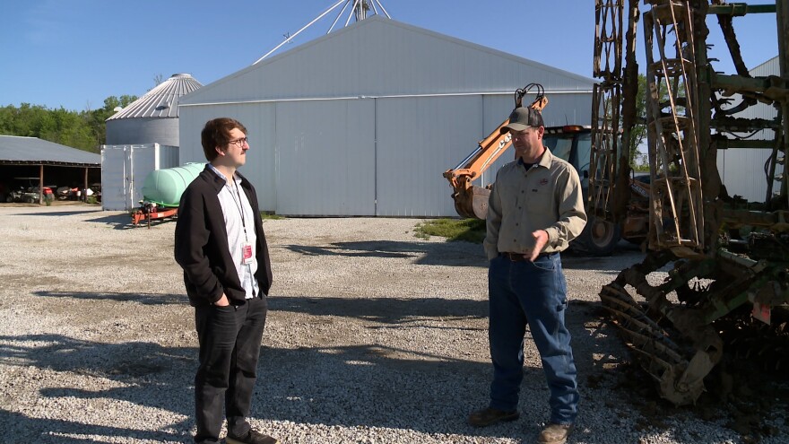 Dwighth Ludwig (right) speaks with reporter Clayton Baumgarth about how tariffs are impacting his operation.