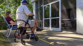 Ann Pautler (from left) and her father Albert Pautler visit their mother and wife, Marilyn Pautler, at the Elderwood at Lancaster nursing home in August. Many nursing homes are only offering outdoor visitation.