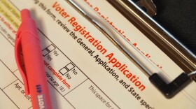 A stack of clipboards with blank voter registration application forms sits on a volunteer table after a naturalization ceremony at the federal courthouse in downtown Indianapolis on Thursday, July 3, 2025.