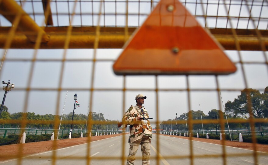 An Indian security personnel stands guard near India Gate ahead of the Republic Day Parade in New Delhi on Saturday. President Obama will attend the parade on Monday.
