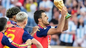 Spain's Rodri (16) lifts the winners' trophy after their win in the World Cup final soccer match against Argentina in East Rutherford, N.J., near New York, Sunday, July 19, 2026.