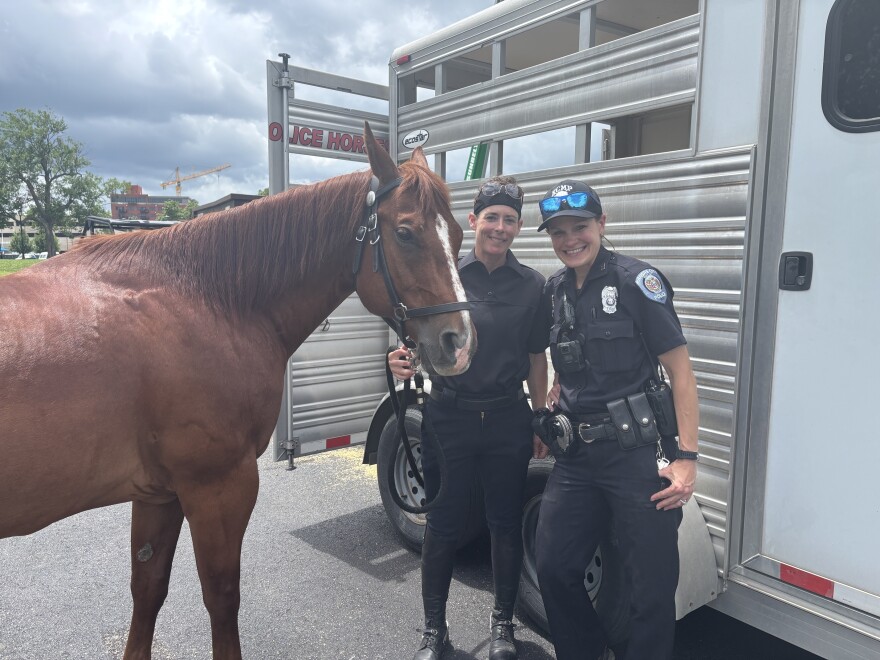 Two mounted patrol officers pose with a St. Charles, Missouri, police horse at Fan Fest