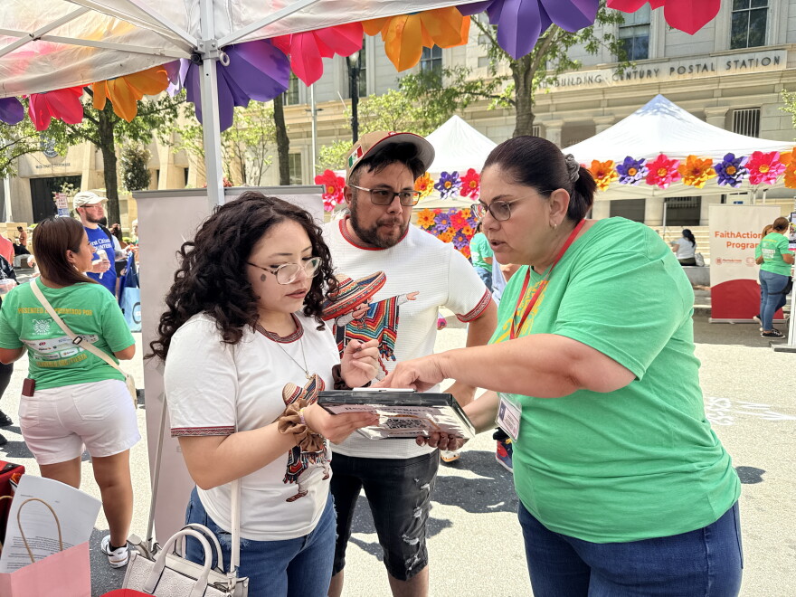 An El Pueblo volunteer helping register a voter at Fiesta del Pueblo, a festival El Pueblo organized in downtown Raleigh on Sept. 20, 2026.