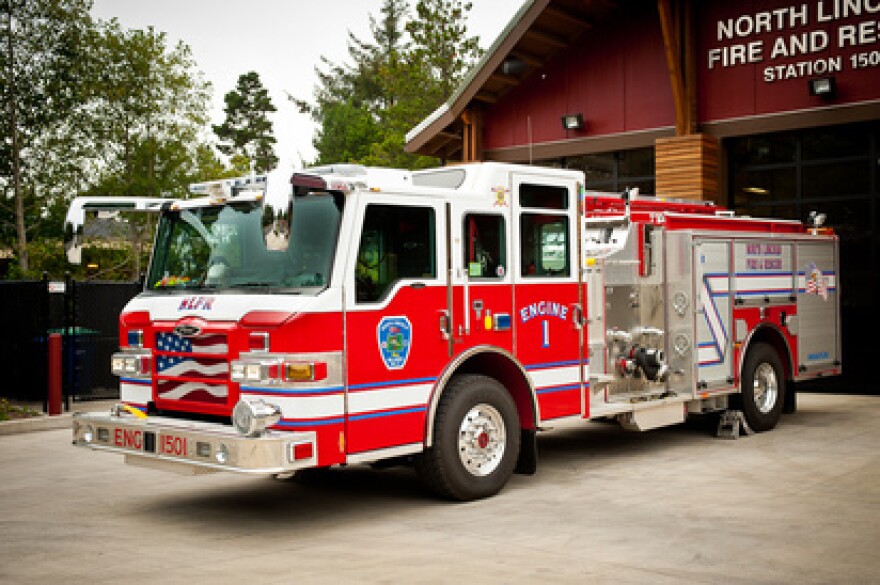 Fire truck parked in front of fire station.