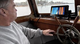 Ralph Bonniville looks at radar to steer toward derelict fishing gear in the York River on Monday, Feb. 10, 2025.