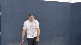 Rep. Johnny Olszewski prepares to serve in a pickleball game at the Jacksonville Recreation Center