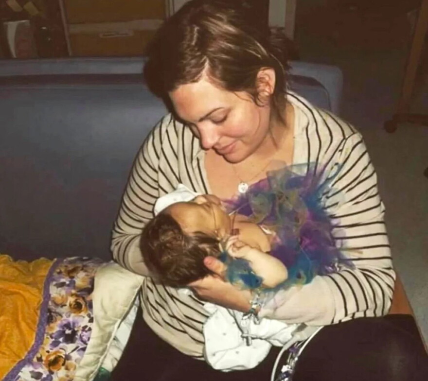 a woman holds a baby