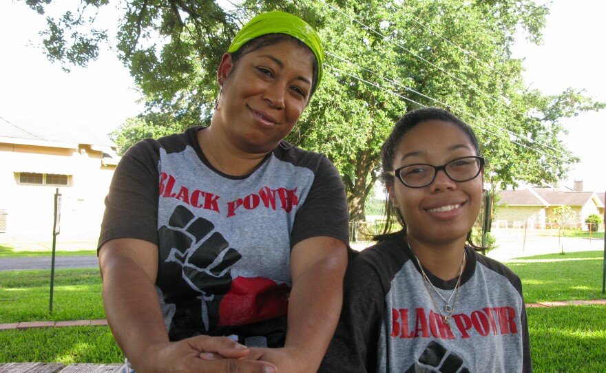 Angelique Mitchell, with her daughter, Ariel, says the community was kept in the dark about the giant grain terminal next door, and their own parish council refuses to put it on the agenda.