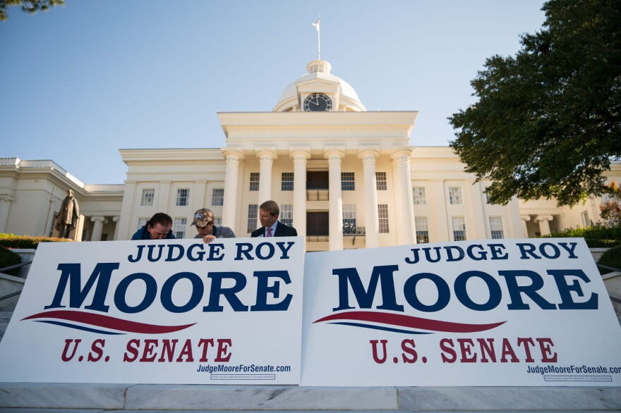 Campaign staff members set up signs before the start of a 'Women For Moore" rally in support of Republican candidate for U.S. Senate Roy Moore, in front of the Alabama State Capitol, Nov. 17, 2017 in Montgomery, Ala.
(Drew Angerer/Getty Images)