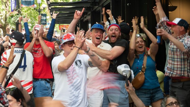 People in U.S. colors cheer. 