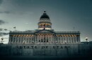 "State of Utah" sign with the Utah capitol building in the background. 