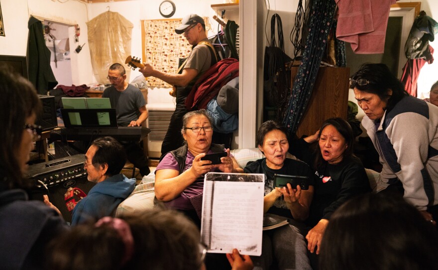 On Sunday night, people gather and practice singing hymns for George Paul Miisaq's funeral. Miisaq was living in Anchorage and his body was flown back to Toksook Bay to be buried.
