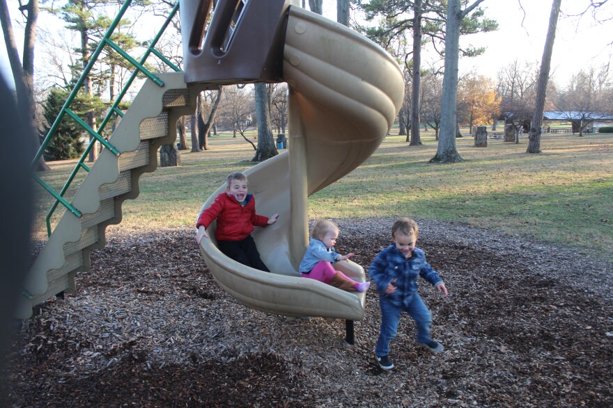 Oren, Ellowyn and Avyn Wood play at Phelps Grove Park in December 2025.