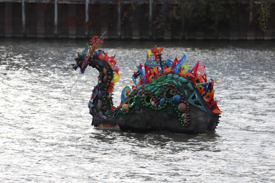 Bessie, made of plastic trash, floating along Cuyahoga River