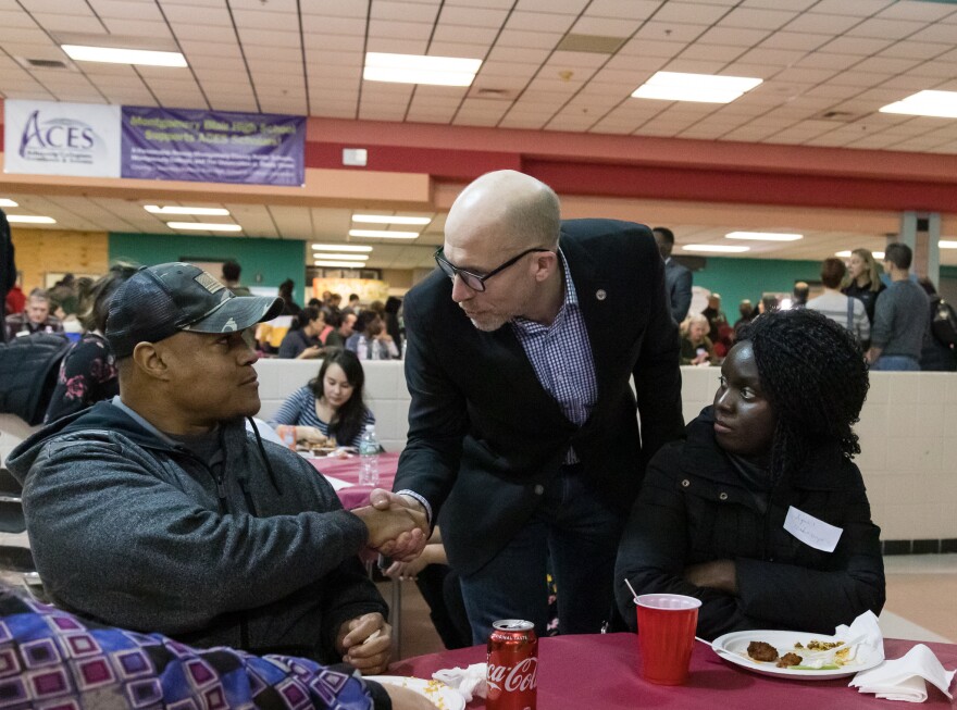 Montgomery County Council Member Tom Hucker checks in with furloughed workers at a community potluck he organized.