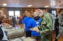 Tallahassee City Commissioner Curtis Richardson (at left) serves up some conversation along with a breakfast plate for a vet.