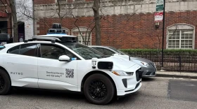 A Google-operated Waymo vehicle drives through Chicago’s Near North Side, with a driver, as the company begins testing and mapping the city in March 2026.