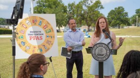 Sarah Burns, is the water planning manager for the City of Tampa, she wears a light grey dress and has red hair. 