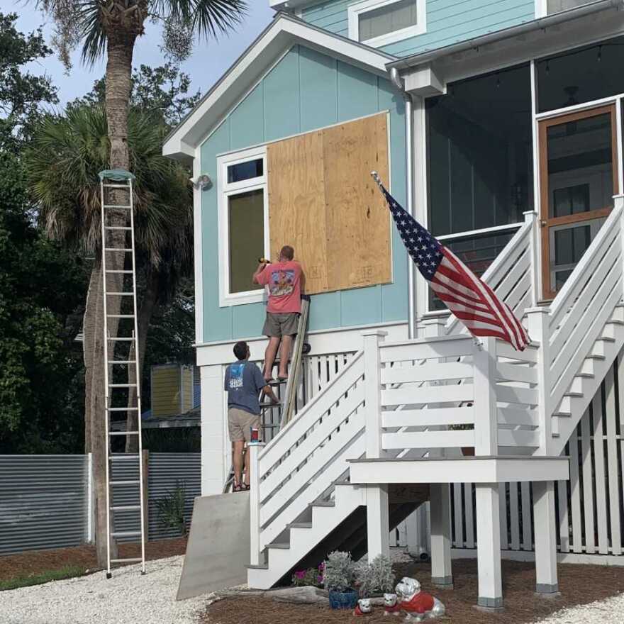 Neal Estroff and a friend board up his house on Tuesday in Tybee Island, Georgia, in anticipation of Hurricane Dorian.