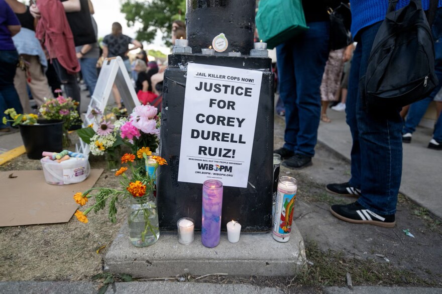 Candles and flowers are placed in memory of Corey Ruiz on Thursday, July 23, 2026, in Madison, Wis.