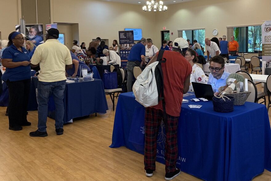 Residents walk around and talk with various community health organizations at the Health Fair and Falls Expo at the Alachua County Senior Recreation Center.