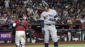New York Yankees' Aaron Judge, right, grimaces after a called third strike as Arizona Diamondbacks catcher Gabriel Moreno, left, heads to the dugout during the third inning of a baseball game Tuesday, April 2, 2024, in Phoenix. (AP Photo/Ross D. Franklin)
