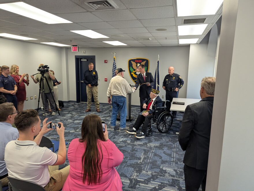 First Assistant U. S. Attorney Robert Tracci presents the awards to World War Two veterans George Hubbard and James Flinchum.