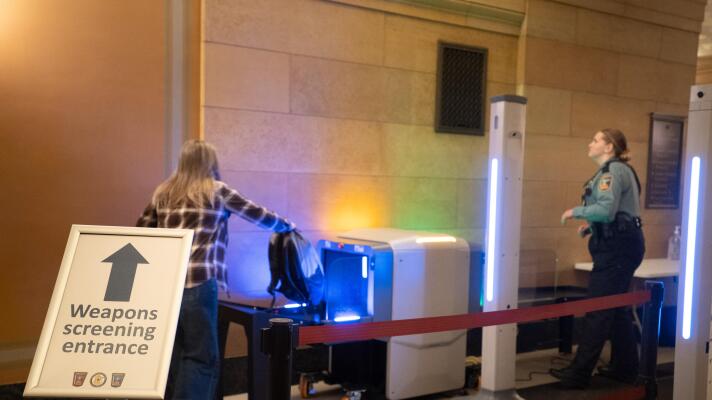 A visitor to the Minnesota State Capitol places a backpack into a scanner on Feb. 19, 2026. New in 2026, visitors are required to go through metal detectors.