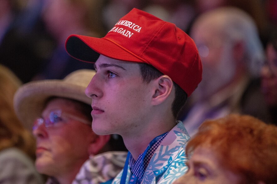 A young supporter in the crowd wears a "Make America Great Again" hat. Donald Trump's 2016 campaign slogan is the clear message of the CPAC.