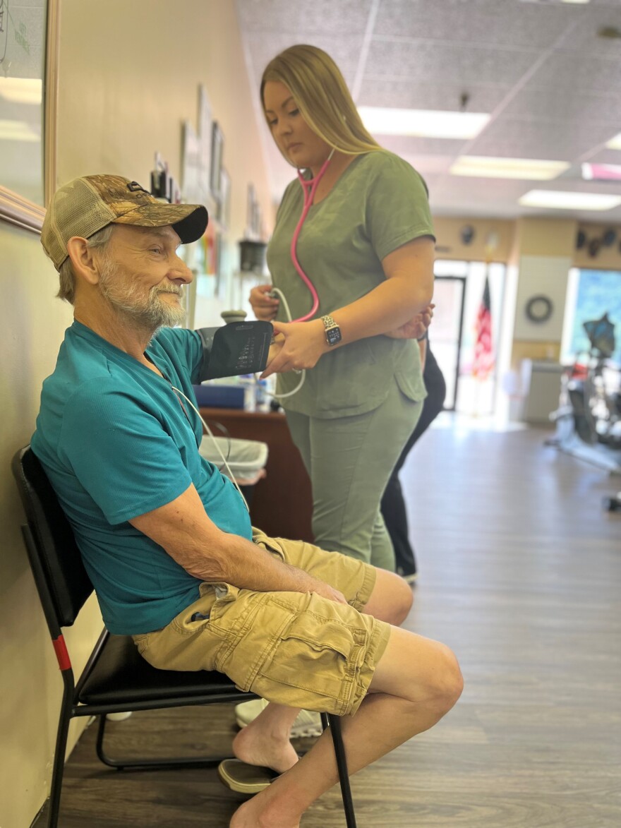 Gary Cook was an underground miner for 32 years. He regularly exercises at New Beginnings Pulmonary Rehab in Norton, Va. Morgan Yeary is checking his blood pressure.