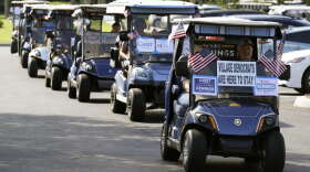A caravan of golf carts head to a polling place to take part in early voting after a campaign event for Rep. Val Demings, D-Fla., candidate for U.S. Senate, Monday, Oct. 17, 2022, in The Villages, Fla. (AP Photo/John Raoux)