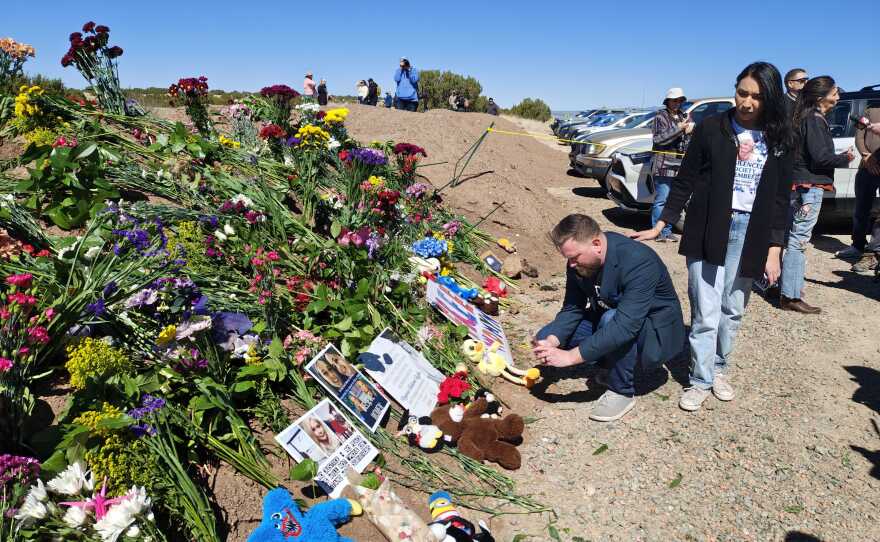 At a makeshift memorial near Zorro Ranch, Sky and Amanda Roberts lay flowers and a sign for Virginia Giuffre, Sky Robert's sister, who alleged abuse at the hands of Epstein before committing suicide last year.