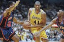 FILE - Elden Campbell (41) of the Los Angeles Lakers drives to the basket as Buck Williams left, and Charlie Ward of the New York Knicks defend, during the second half of their game on Sunday, Feb. 23, 1997 in Inglewood, Calif. (AP Photo/Mark J. Terrill, File)