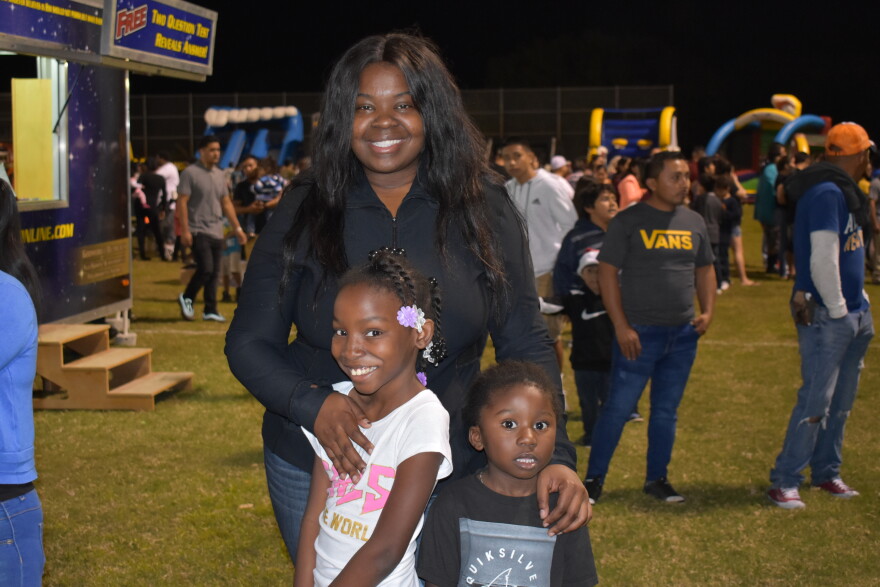 Kristie Pierre poses with her niece and nephew at the 2018 Christmas around the world festival in Immokalee.