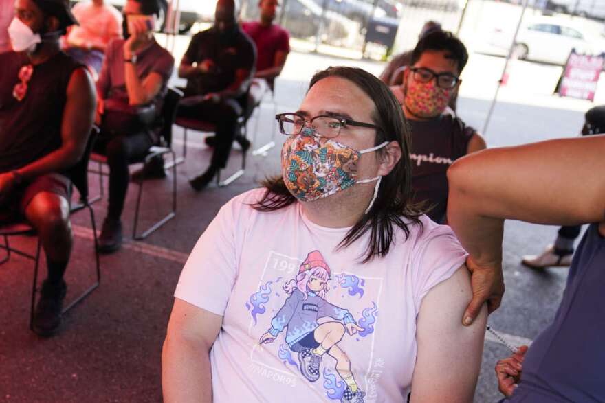 Anthony Madrid receives a dose of the monkeypox vaccine at a walk-in clinic at the North Jersey Community Research Initiative in Newark, N.J., Tuesday, Aug. 16, 2022. (AP Photo/Seth Wenig)