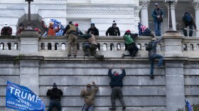 Supporters of President Trump climb the West wall of the U.S. Capitol on Jan. 6. (Jose Luis Magana/AP)