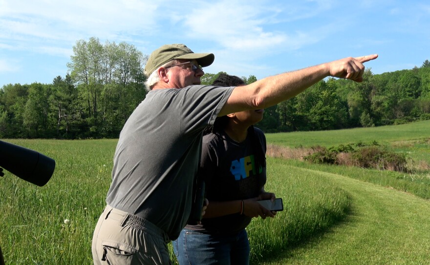 Ornithologist David Sibley points a bird out to Kaliis Smith.