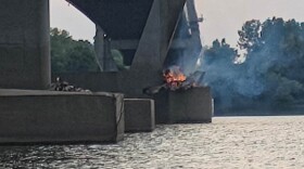 A fire burns under the William Natcher Bridge near Owensboro