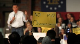 An audience member decries President Obama's economic policies as Republican presidential candidate Mitt Romney speaks during a February campaign rally in Atlanta.