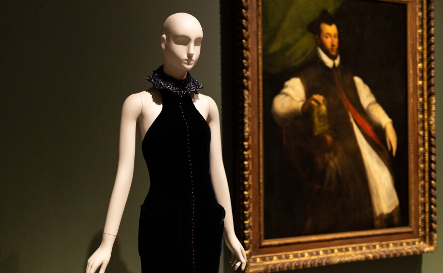 The stark silhouette of a 2021 Giorgio Armani dress echoes the formal elegance of a 16th-century portrait of an Italian prelate by Girolamo Carpi, part of the permanent collection of the Cleveland Museum of Art.