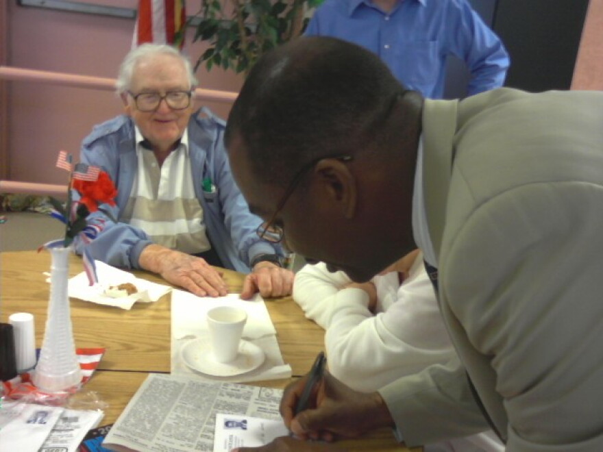 Mayor Brown signs a promissory note at Autumnwood Senior Center on Clinton Street