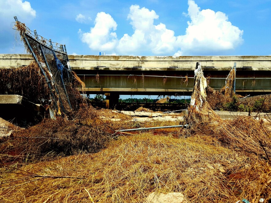 Floodwaters from last month's storm ripped apart fences and flooded Interstate 10 east of Houston. The San Jacinto Waste Pits Superfund site is just on the other side of the road.