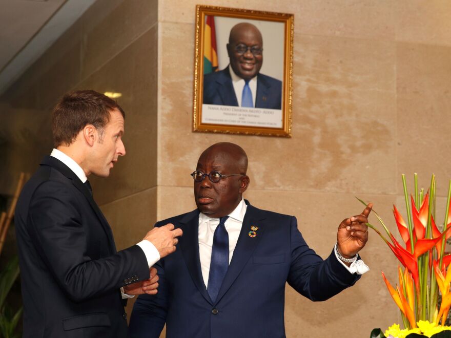 Ghanaian President Nana Akufo-Addo speaks with French President Emmanuel Macron at the presidential palace in Accra.