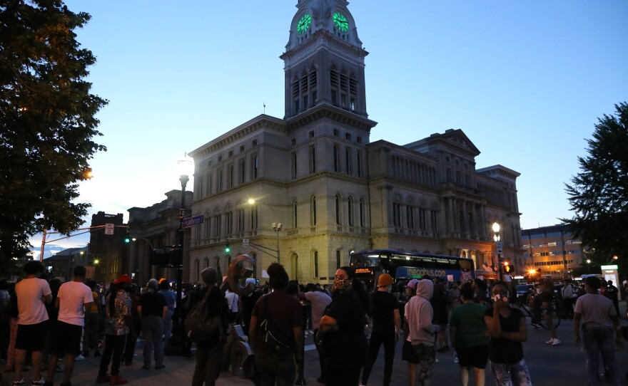 Protesters begin to gather outside City Hall in Louisville, Ky., on Thursday. The crowds formed not long after the release of a 911 call from Breonna Taylor's boyfriend on the night she died.