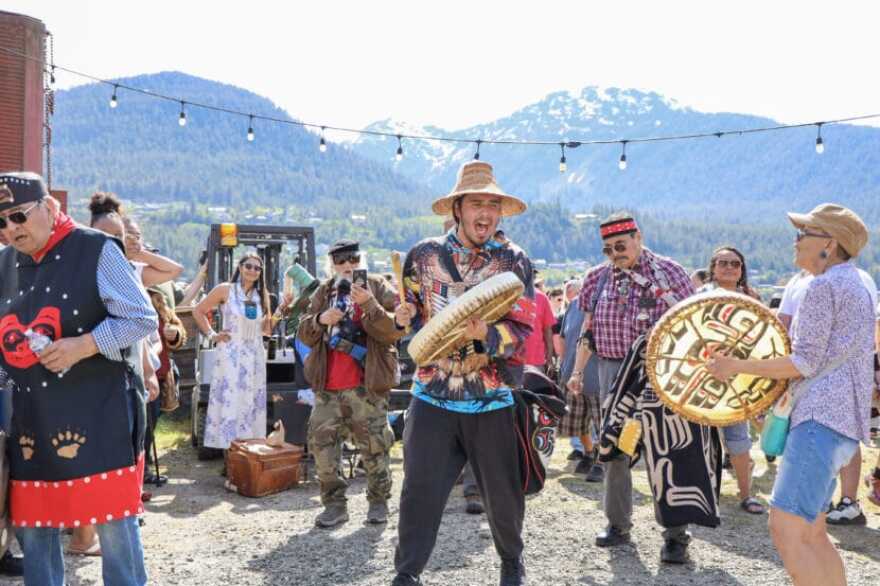 Sheeshan Colin Rose sings as paddles arrive in downtown Juneau for Celebration on Tuesday, June 2, 2026.