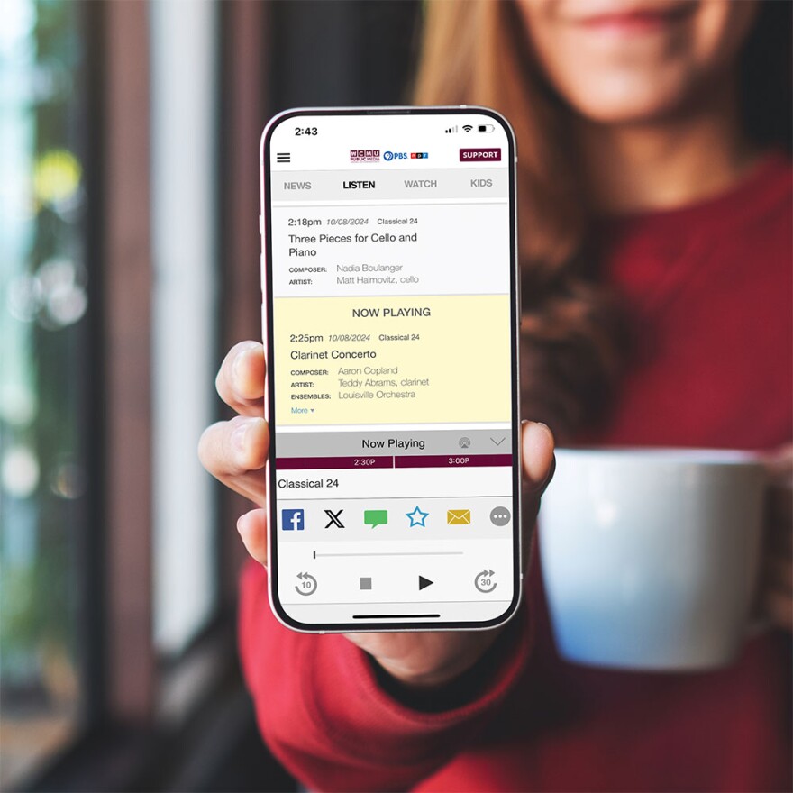 An image of a woman holding a phone that's displaying the WCMU Public Media App