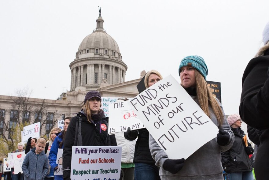 Teachers, students and supporters march in front of the capitol on April 2 during a walkout aimed at increasing education funding.