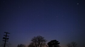 A Geminid meteor streaks across the sky early Friday near Scotland, Md.