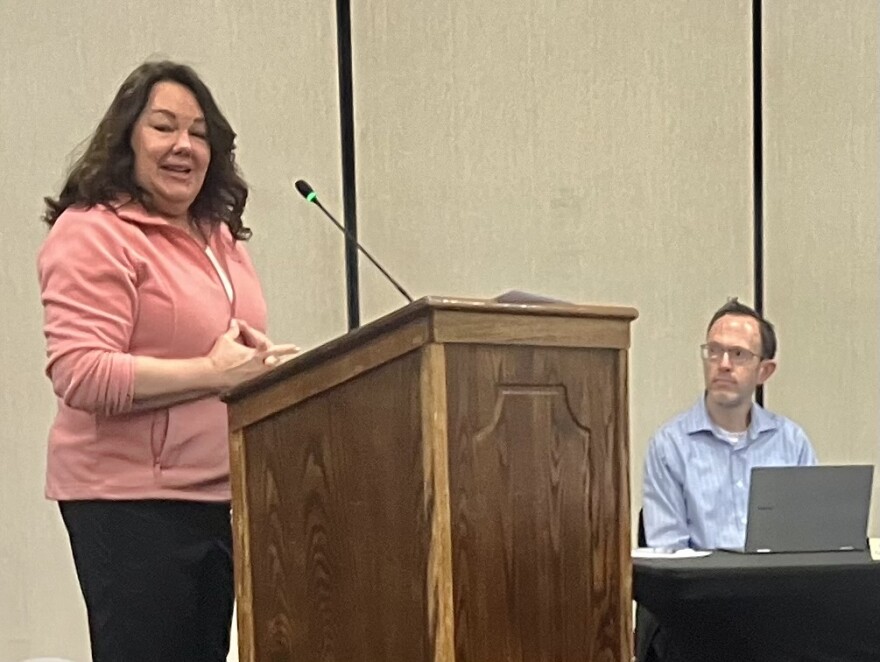 Robin Leasure, who said she lives 380 feet away from a proposed adult-use cannabis dispensary in Washington, speaks out against the facility Monday at a City Council meeting. Listening is Jon Oliphant, the city's planning and development director.