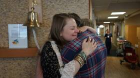 Carmen, Tom and Buck Breedlove embrace after Carmen's final chemotherapy infusion at the IU Health Simon Cancer Center.